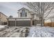 Charming two-story home with attached three-car garage and brick accents, perfect for a growing Gathering at 6550 S Oak Ct, Littleton, CO 80127