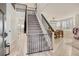 Inviting foyer with light wood flooring, modern black railings, and abundant natural light from large windows at 6550 S Oak Ct, Littleton, CO 80127
