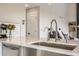 Close-up of a modern kitchen sink with a stainless steel faucet and subway tile backsplash at 6550 S Oak Ct, Littleton, CO 80127
