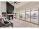 Cozy living room with fireplace and sliding glass doors leading to the outdoor patio at 6550 S Oak Ct, Littleton, CO 80127