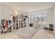 Versatile room with wood floors, perfect as playroom with abundant natural light and storage at 6550 S Oak Ct, Littleton, CO 80127