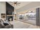 Living room with fireplace and large sliding doors to a covered outdoor patio at 6550 S Oak Ct, Littleton, CO 80127