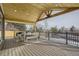 Covered outdoor patio with dining area and a view of the neighborhood at 6550 S Oak Ct, Littleton, CO 80127