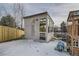 Charming shed in a snowy backyard, featuring a playhouse and fenced yard at 6550 S Oak Ct, Littleton, CO 80127