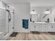 Modern bathroom featuring double vanities, a glass shower, and stylish tile work at 4418 Soapberry Pl, Castle Rock, CO 80108