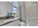 Bathroom featuring a white vanity, a shower-tub combo with a shower curtain and a window at 4418 Soapberry Pl, Castle Rock, CO 80108