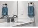 Bathroom sink and countertop featuring a black faucet, towel rack and modern design at 4418 Soapberry Pl, Castle Rock, CO 80108