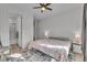 Bright bedroom with hardwood floors, ceiling fan, and ensuite bathroom with tiled shower at 4418 Soapberry Pl, Castle Rock, CO 80108
