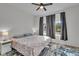 Cozy bedroom with a queen-size bed, neutral walls, and a large window with sheer curtains at 4418 Soapberry Pl, Castle Rock, CO 80108