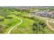 Aerial view showcases a neighborhood surrounded by green spaces, walking paths, and natural beauty at 4418 Soapberry Pl, Castle Rock, CO 80108