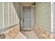 Covered front entryway with stone accents and stylish door at 4418 Soapberry Pl, Castle Rock, CO 80108