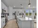 Beautiful kitchen featuring stainless steel appliances, white cabinetry, a large island, and an exterior view at 4418 Soapberry Pl, Castle Rock, CO 80108