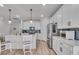 Bright kitchen features modern appliances, white cabinets, an island with seating, and a stylish backsplash at 4418 Soapberry Pl, Castle Rock, CO 80108