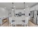 Bright kitchen features modern appliances, white cabinets, an island with pendant lighting, and stylish backsplash at 4418 Soapberry Pl, Castle Rock, CO 80108