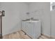Laundry room with modern washer and dryer units, wood-look flooring, and wire shelving at 4418 Soapberry Pl, Castle Rock, CO 80108
