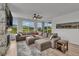 Spacious living room featuring a large sectional sofa, neutral decor, and plenty of natural light at 4418 Soapberry Pl, Castle Rock, CO 80108