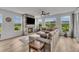 Open living space with a stone fireplace and comfortable seating with scenic views at 4418 Soapberry Pl, Castle Rock, CO 80108