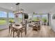 Open living and dining area with hardwood floors, modern lighting, and great natural light at 4418 Soapberry Pl, Castle Rock, CO 80108