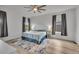 Bright bedroom with a ceiling fan, hardwood floors, curtains, and a large window at 4418 Soapberry Pl, Castle Rock, CO 80108