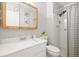 Bright bathroom features a modern vanity, stylish mirror, and a tiled shower at 770 S Youngfield, Lakewood, CO 80228