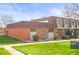 A low brick-exterior home with a manicured lawn and lovely landscaping at 770 S Youngfield, Lakewood, CO 80228