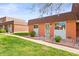 Charming brick home with manicured lawn and colorful landscape bed at 770 S Youngfield, Lakewood, CO 80228