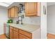 Charming kitchen with stainless steel dishwasher, light wood cabinets, and a modern faucet at 770 S Youngfield, Lakewood, CO 80228