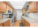 Well-lit kitchen features modern appliances, light cabinets, and plenty of counter space at 770 S Youngfield, Lakewood, CO 80228