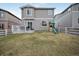 Well-maintained backyard featuring a patio, playset, and lawn with partial fencing at 5354 Blue Lunar Ln, Castle Rock, CO 80104