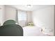 Bright, neutral-toned bedroom featuring a crib, soft carpet, and plenty of room to play at 5354 Blue Lunar Ln, Castle Rock, CO 80104