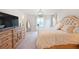 Luxurious main bedroom suite with an opulent bed, detailed dresser, and a bright sitting area at 5354 Blue Lunar Ln, Castle Rock, CO 80104