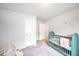 This bright bedroom features a grey carpet and a colorful crib with plenty of room to play at 5354 Blue Lunar Ln, Castle Rock, CO 80104