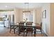 This dining room features a dark wood table, elegant lighting, and views of the kitchen at 5354 Blue Lunar Ln, Castle Rock, CO 80104