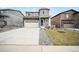 Charming two-story home featuring stone accents, a well-manicured lawn, and a spacious driveway at 5354 Blue Lunar Ln, Castle Rock, CO 80104