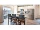 Modern kitchen featuring granite counters, stainless appliances, a breakfast bar, and sleek cabinets at 5354 Blue Lunar Ln, Castle Rock, CO 80104