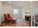 Comfortable office with hardwood floors, a stylish red chair, and a classic wooden desk at 5354 Blue Lunar Ln, Castle Rock, CO 80104