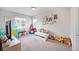 Bright and cheerful play room with soft carpet and windows for natural light at 5354 Blue Lunar Ln, Castle Rock, CO 80104