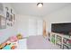 Bright play room featuring soft carpet, a window for natural light, and space for a television at 5354 Blue Lunar Ln, Castle Rock, CO 80104
