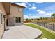 Well-maintained backyard with a concrete patio, grassy area, a fence, and an exterior storage closet at 913 Alkire Ct, Golden, CO 80401