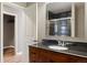 Bathroom featuring a wood vanity with stone countertop and a glass-enclosed shower at 913 Alkire Ct, Golden, CO 80401