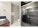 Modern bathroom featuring a glass shower with stylish dark tile and a sleek vanity with a black countertop at 913 Alkire Ct, Golden, CO 80401