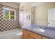 Bathroom with checkered tiling in the shower/bath and a large mirror over the countertop sink at 913 Alkire Ct, Golden, CO 80401
