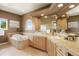 Bathroom featuring a large bathtub and dual sinks with wooden cabinets at 913 Alkire Ct, Golden, CO 80401
