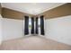 Empty bedroom featuring neutral carpet, baseboard and crown molding, and large windows with dark curtains at 913 Alkire Ct, Golden, CO 80401