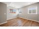 Bright bedroom showcasing wood floors, neutral walls, and natural light streaming through multiple windows at 913 Alkire Ct, Golden, CO 80401