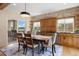 Dining area showcases rustic wood cabinets, brick accent wall, and sliding glass door to balcony at 913 Alkire Ct, Golden, CO 80401