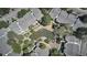 Aerial view showcases condo community with a scenic pond, trees, and walkways at 8600 E Alameda Ave # 17-203, Denver, CO 80247
