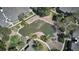 Drone image shows a community with pond, mature trees, and walking paths at 8600 E Alameda Ave # 17-203, Denver, CO 80247