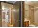 Neutral bathroom with light tan tiles and a tub/shower combo visible through an open door at 8600 E Alameda Ave # 17-203, Denver, CO 80247