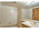 Bathroom features a vanity, mirror and tiled shower over tub combo at 8600 E Alameda Ave # 17-203, Denver, CO 80247